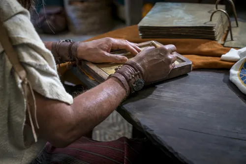 Nephi records his testimony on metal plates.