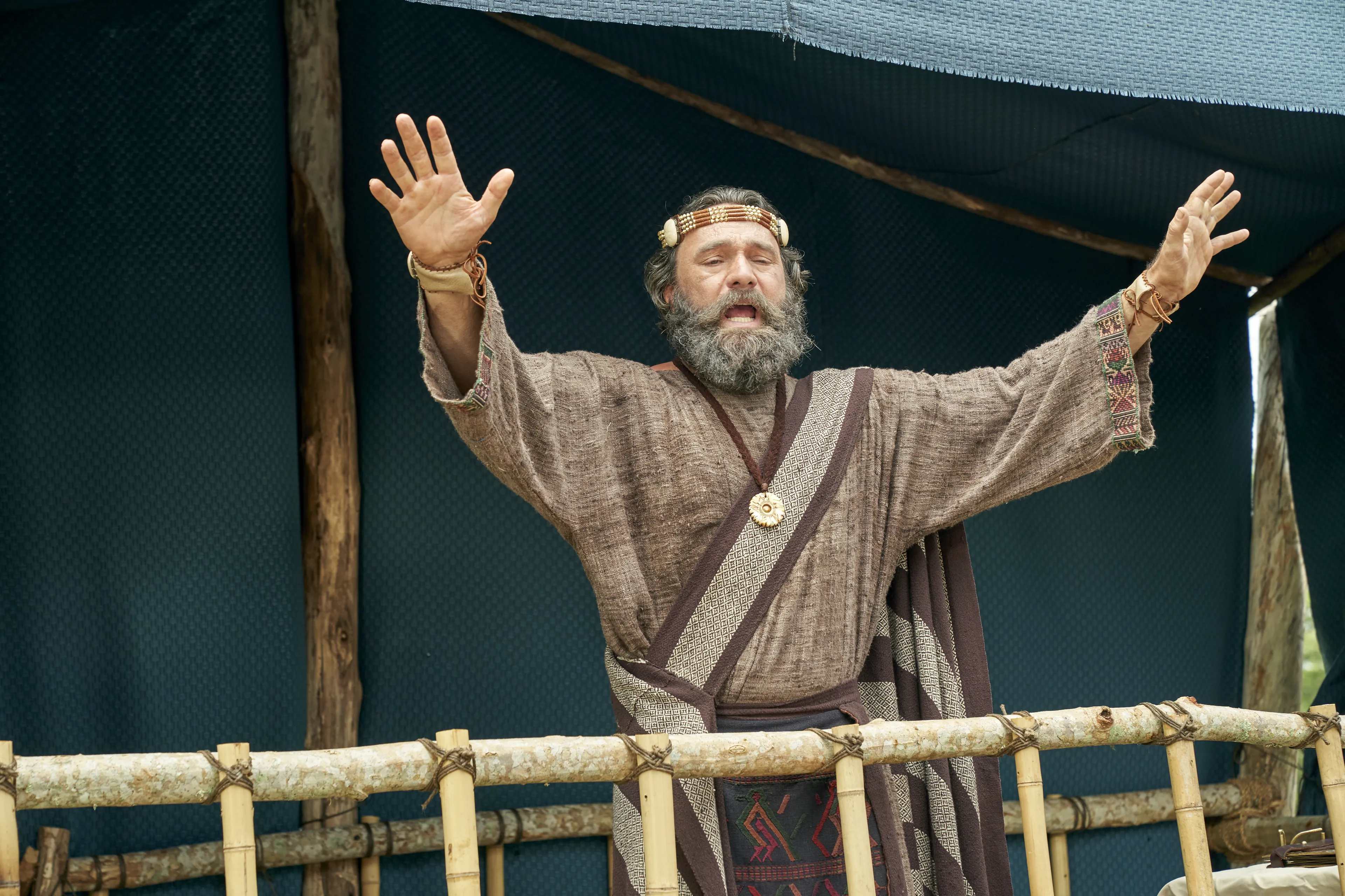 King Benjamin stands on a tower speaking to the Nephites in the Land of Zarahemla.