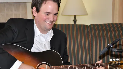 Michael Hinckley playing a guitar.