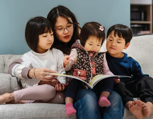 Family looking at a book together