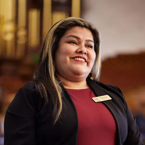 smiling woman standing in Salt Lake Tabernacle
