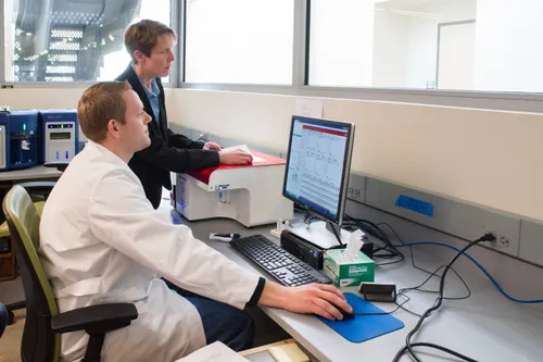 man at computer in lab coat