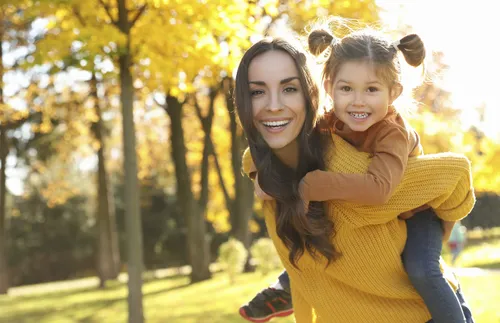 woman and child at the park in the fall