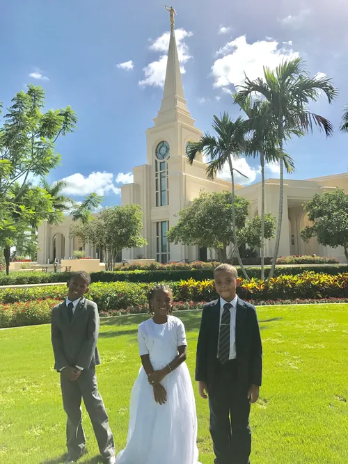 two boys and a girl dressed up outside temple