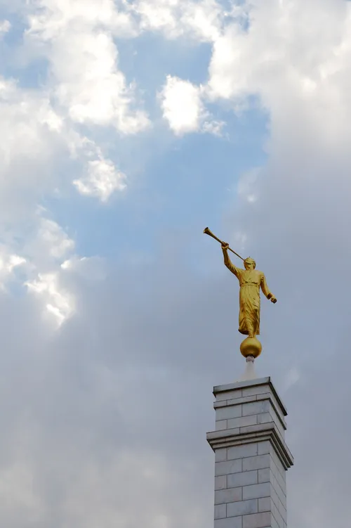 The angel Moroni on top of a gray spire at the Oaxaca, Mexico Temple on a cloudy day.