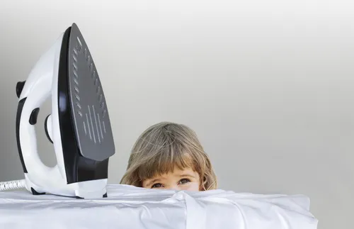 little girl looking at ironing