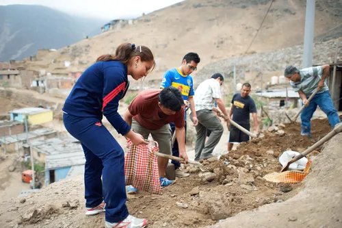people using shovels and other tools