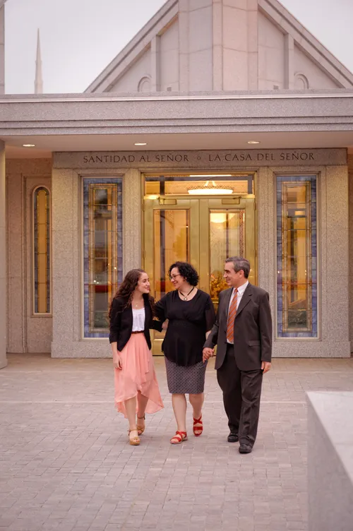 A daughter and her parents dressed in church clothes, walking out of the Buenos Aires Argentina Temple.