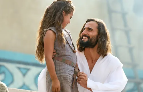 Christ kneeling next to a young girl