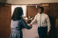 A man welcome a woman visiting the church