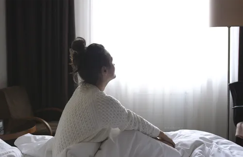 young woman looking out the window