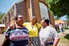 three women visiting in front of the church