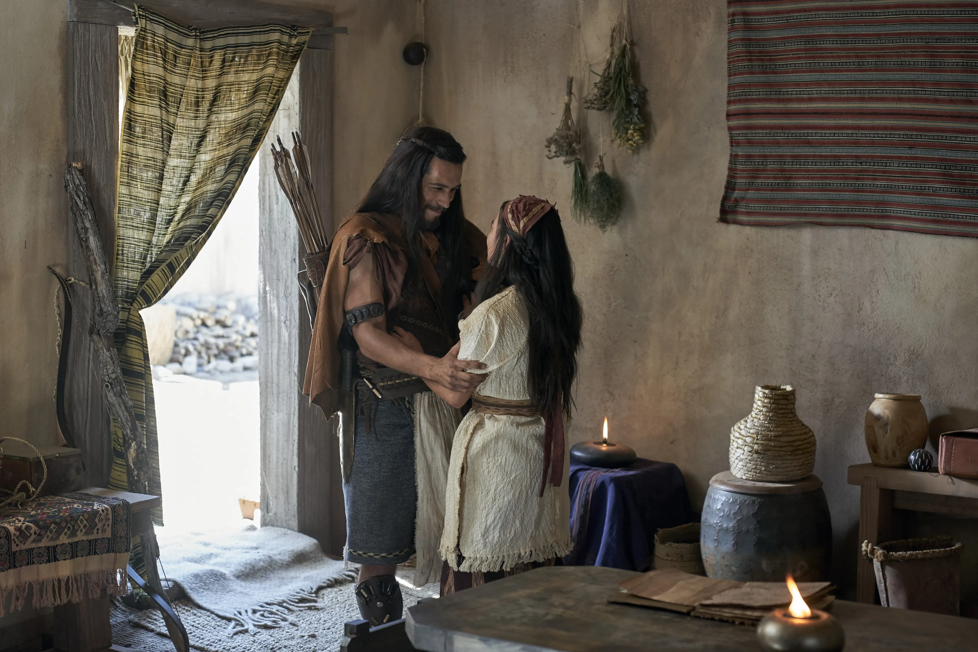 Enos greets his wife in their home.
