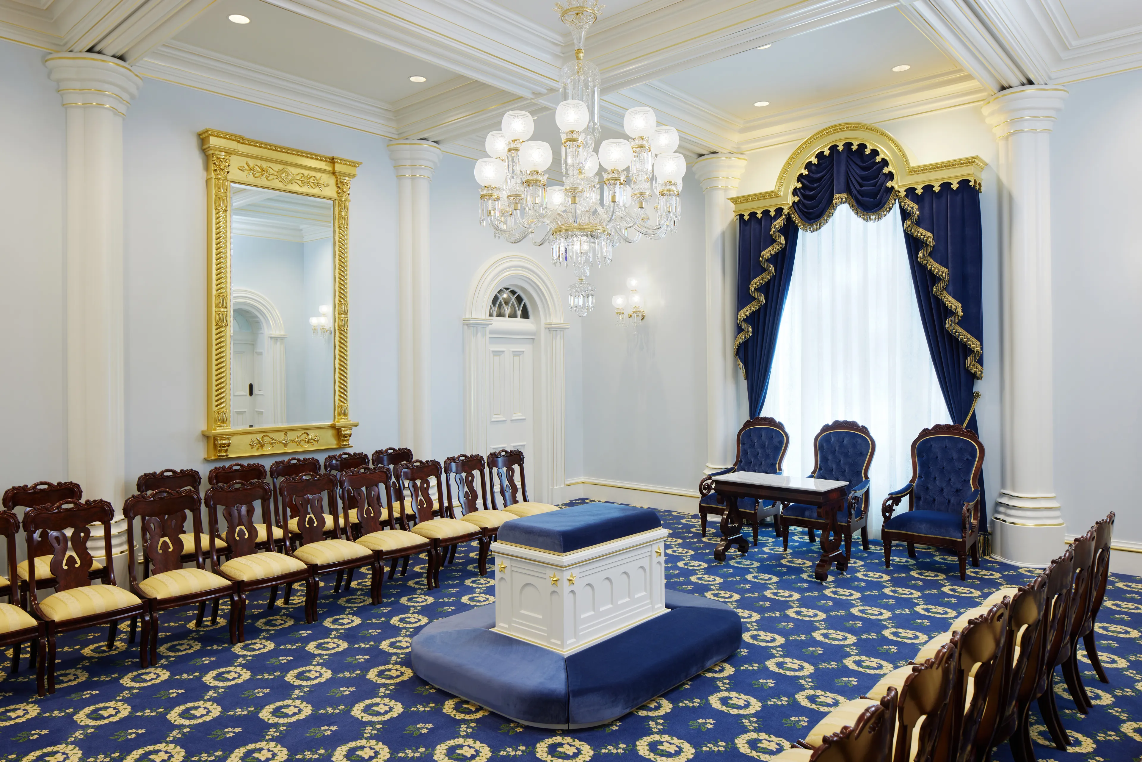 A sealing room in the St. George Utah Temple. An altar is in the center of the room surrounded by chairs.
