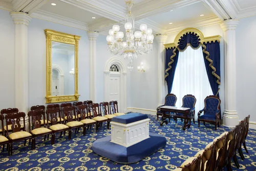 A sealing room in the St. George Utah Temple. An altar is in the center of the room surrounded by chairs.