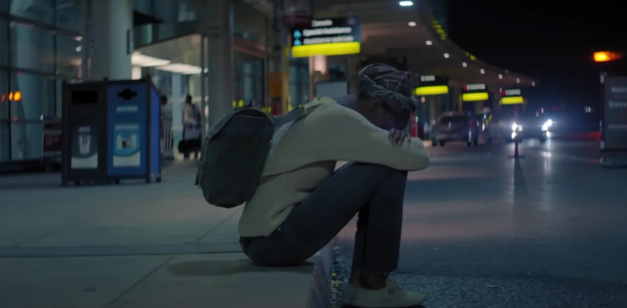 A refugee woman feeling alone at the airport