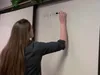woman writing on whiteboard