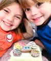 A smiling girl and boy with painted rocks