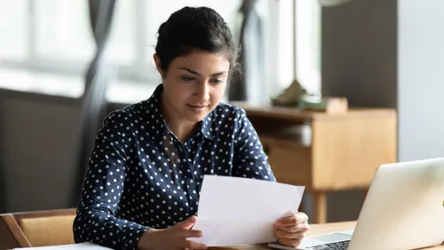 young woman looking at a piece of paper