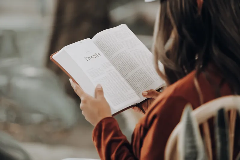A woman reads the book of Proverbs in the Bible