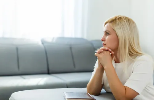 woman kneeling by a couch