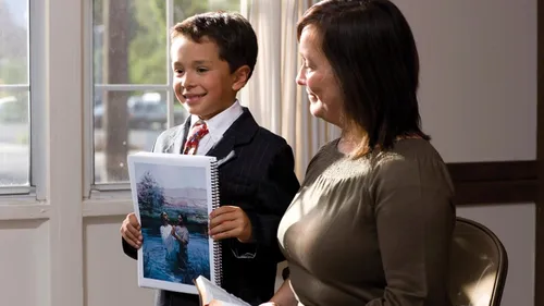 young boy holding picture