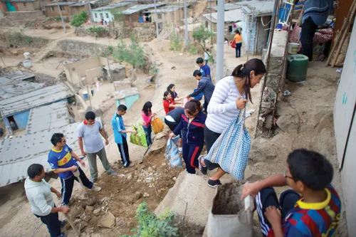youth help with a service project in Peru
