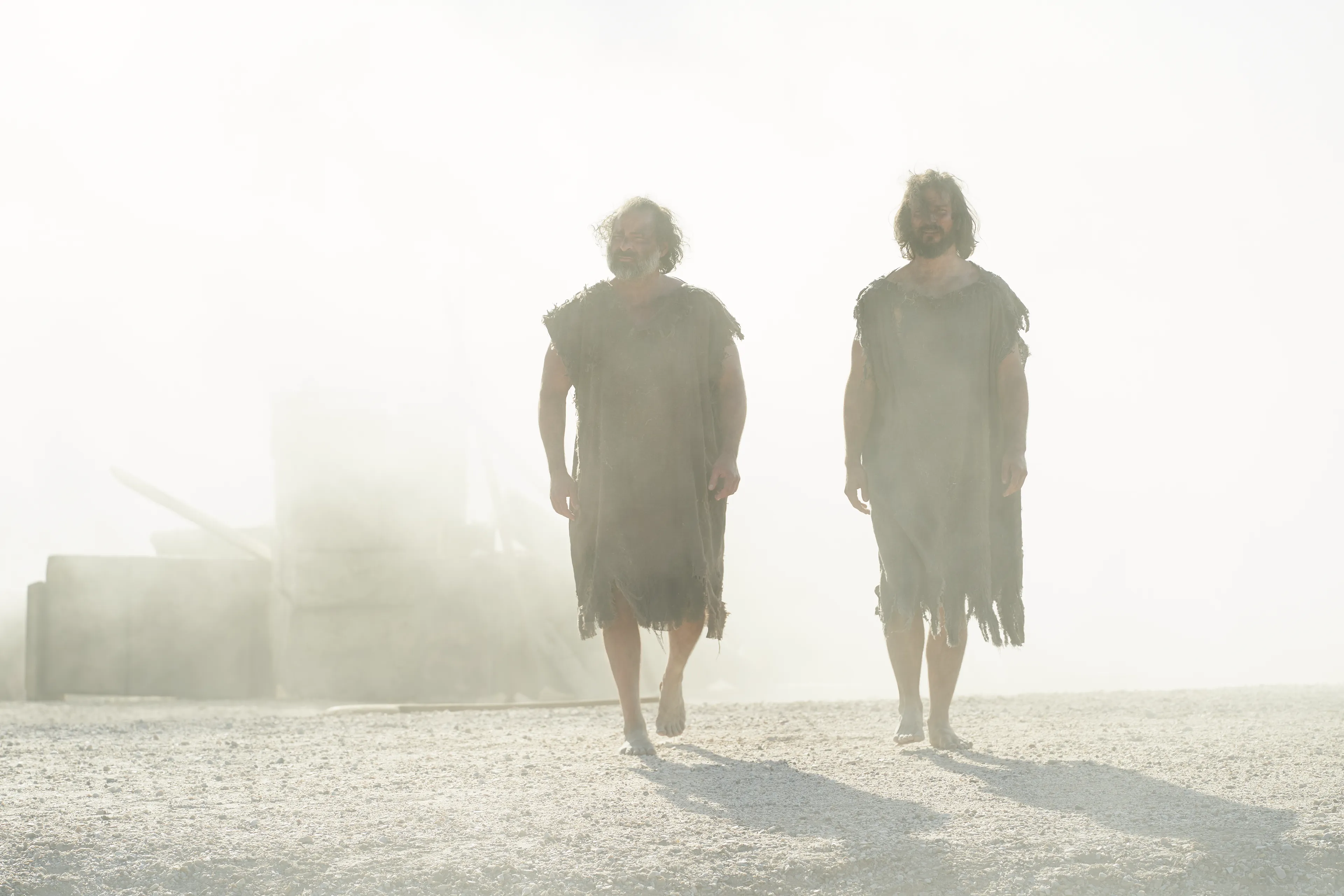 Alma the Younger and Amulek walk away from the ruins of the prison in Ammonihah.