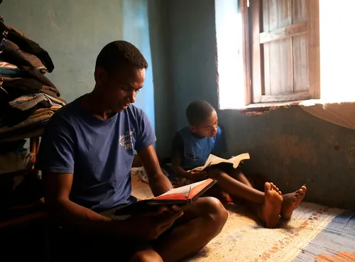 father and son reading scriptures