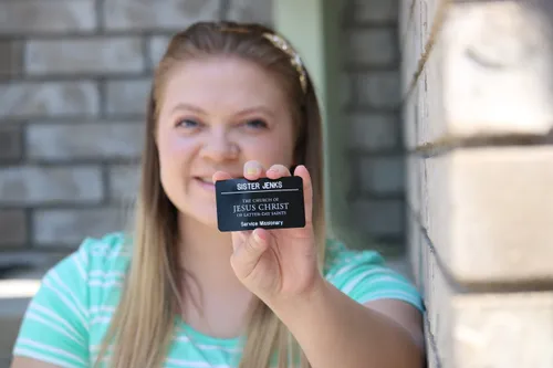sister missionary holding tag