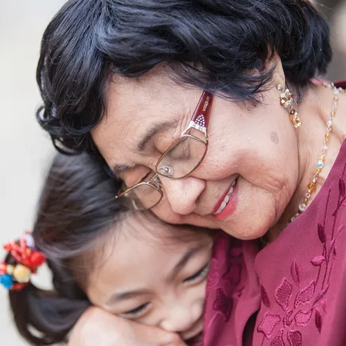 grandmother hugging granddaughter