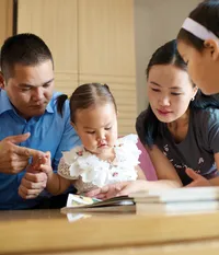 A family looking at scripture stories together.