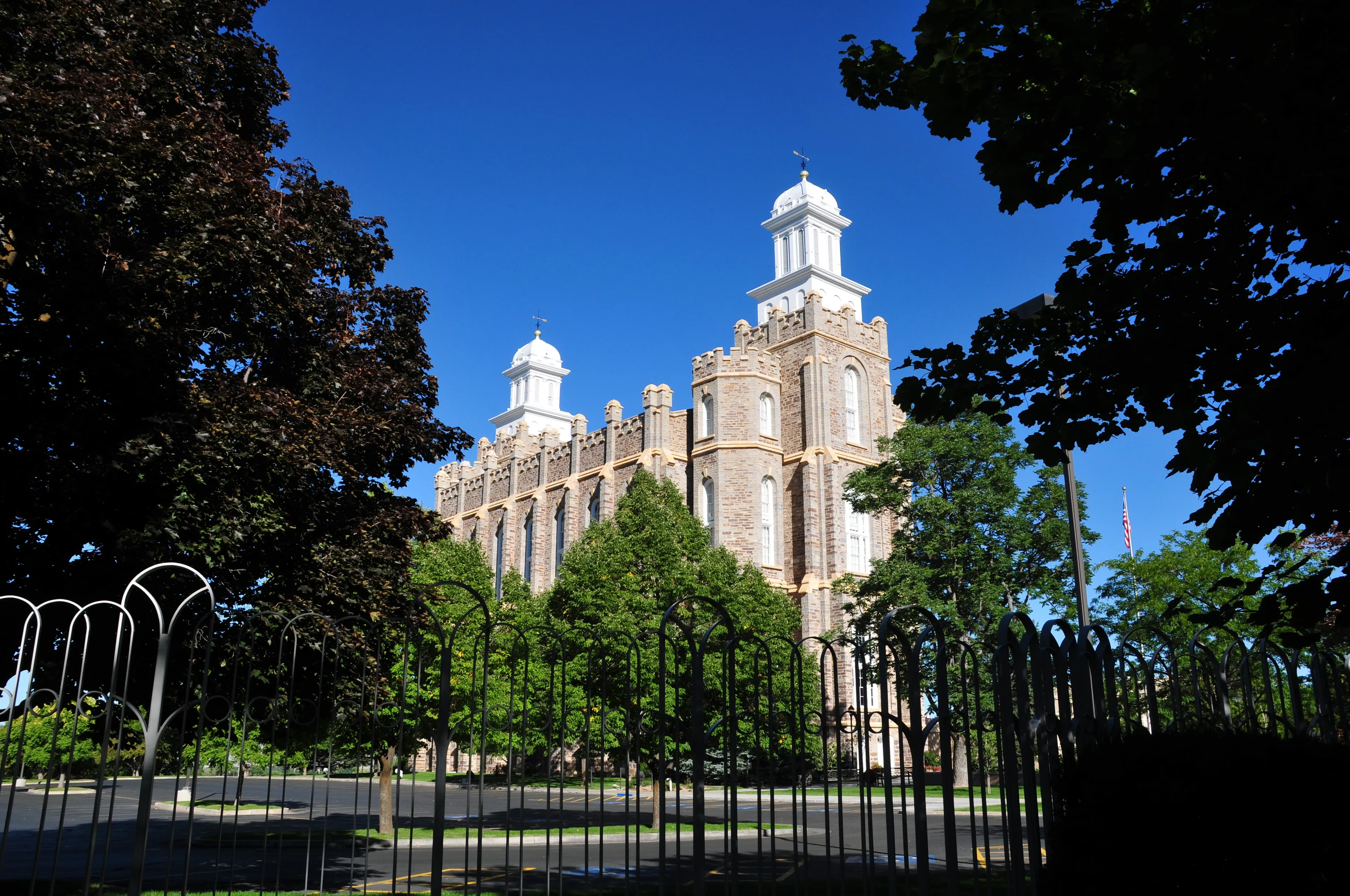 The Logan Utah Temple, including gates and scenery.