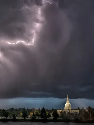 a lightning strike in the sky above a temple
