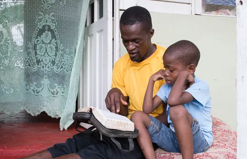 Deneto and son reading scriptures