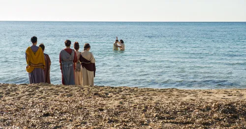 Peter baptizing person in the sea
