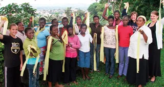 youth in Uganda holding yellow banners