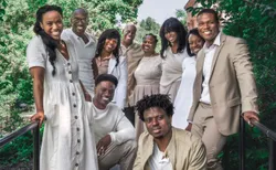 The Bonner family wearing coordinated white and tan outfits posing for a portrait