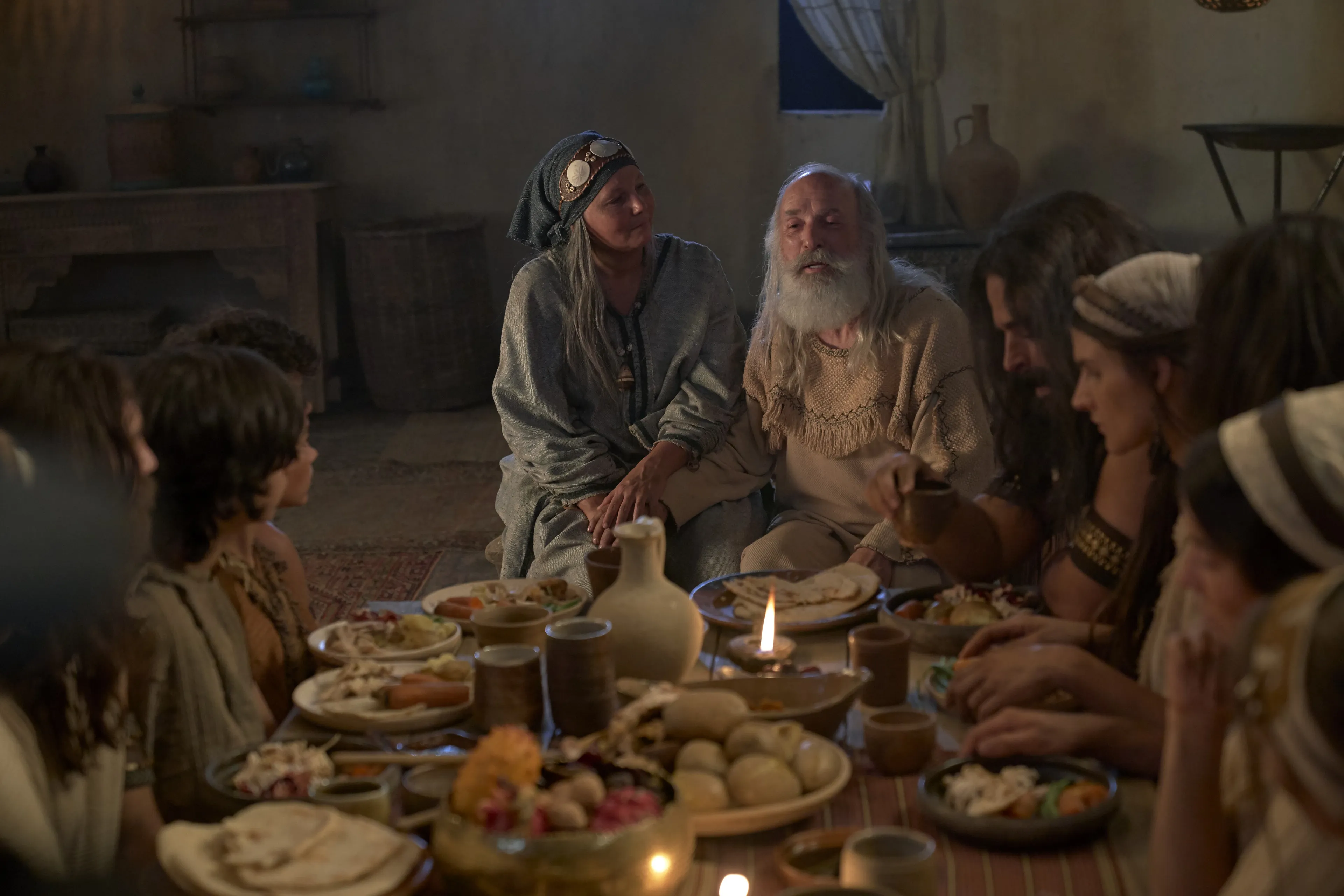 Lehi and Sariah teach their family while dining.