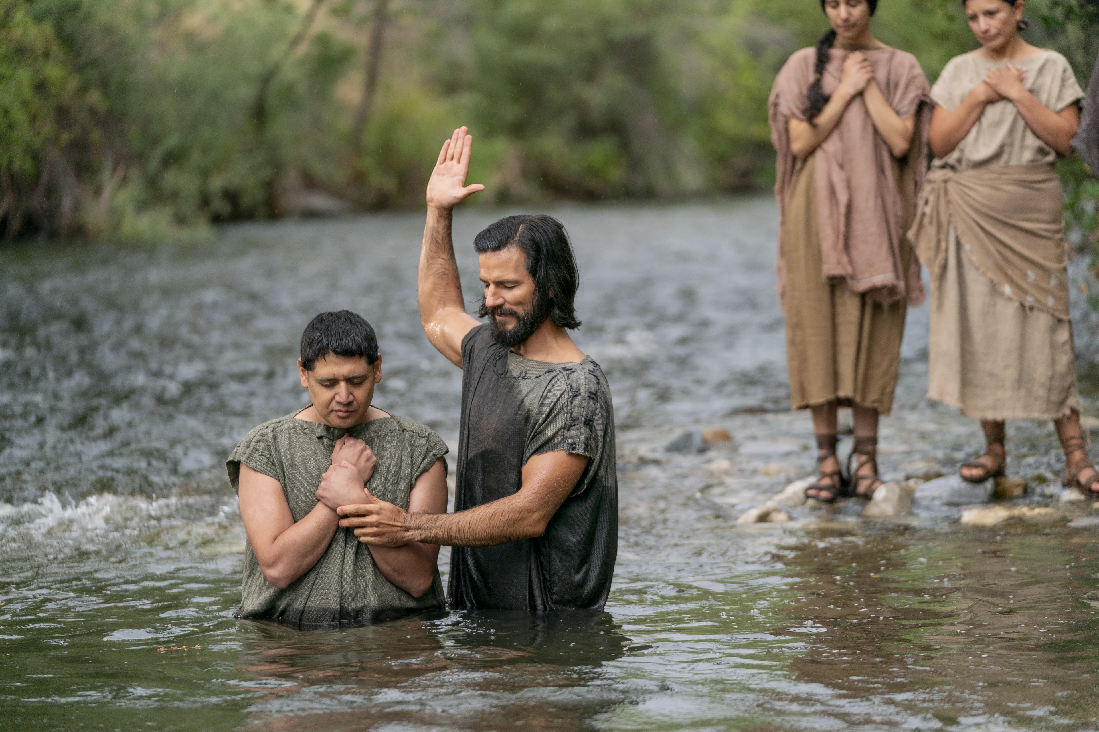 Alma the Younger baptizes believers in the land of Zarahemla.