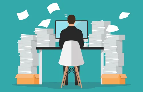 an illustration of a man working at a computer, surrounded by stacks of papers