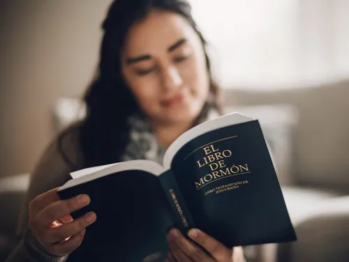 young woman reading the Book of Mormon