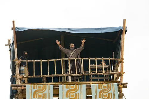 King Benjamin stands on a tower speaking to the Nephites in the Land of Zarahemla.