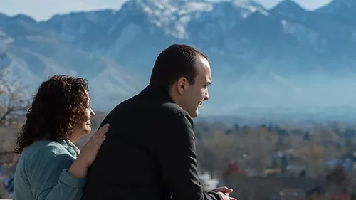 man and woman looking at mountains