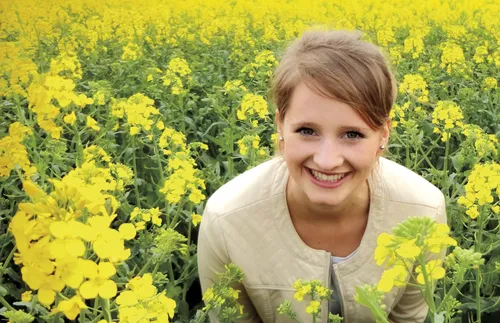 young woman in field of flowers