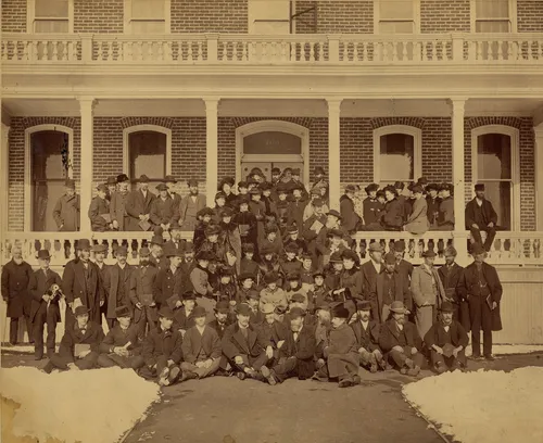 View of choir members on porch and sidewalk in front of John Sharp's house at 409 First Avenue in Salt Lake City, Utah, where they had come to serenade Bishop Sharp and his family on New Year's Day