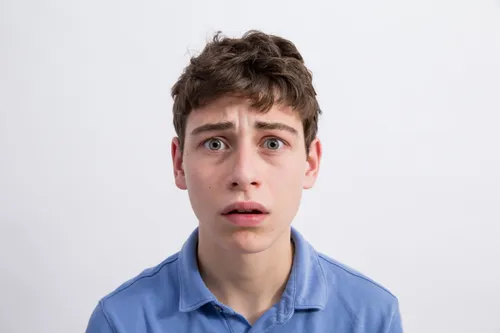 a young man with a worried expression