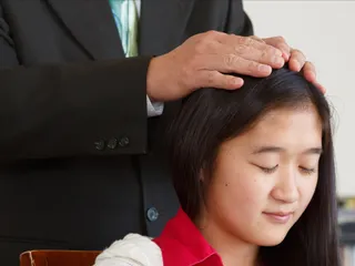 man giving young woman blessing