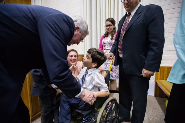 Elder D. Todd Christofferson greeting a young man at a youth devotional in Porto Alegre, Brazil, March 2017.