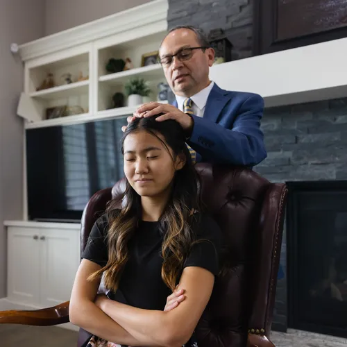 a patriarch giving a young woman a blessing